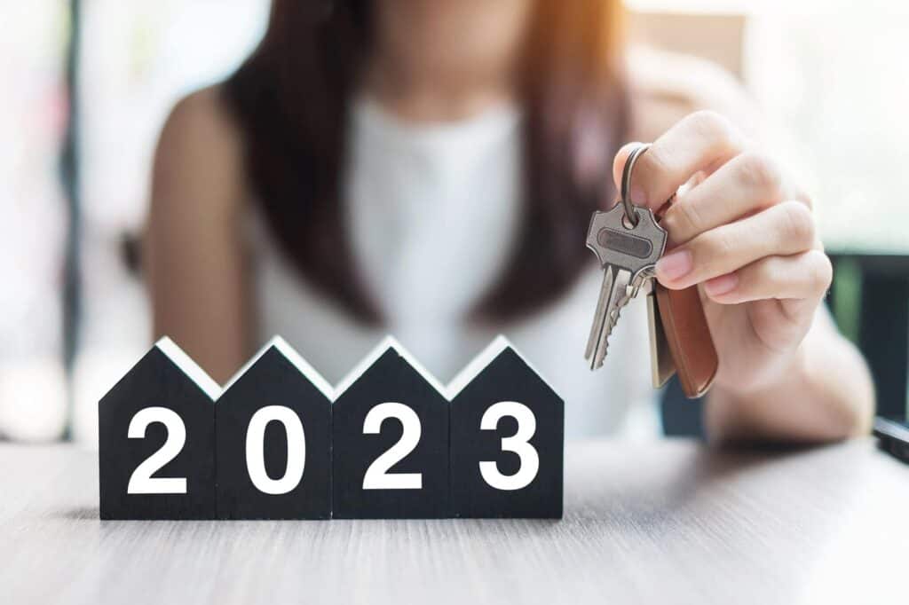 Businesswoman Hands Holding Key 2023 Happy New Year With House Model Table Office New House Financial Property Insurance Real Estate Savings New Year Resolution Concepts Min 1024x682 