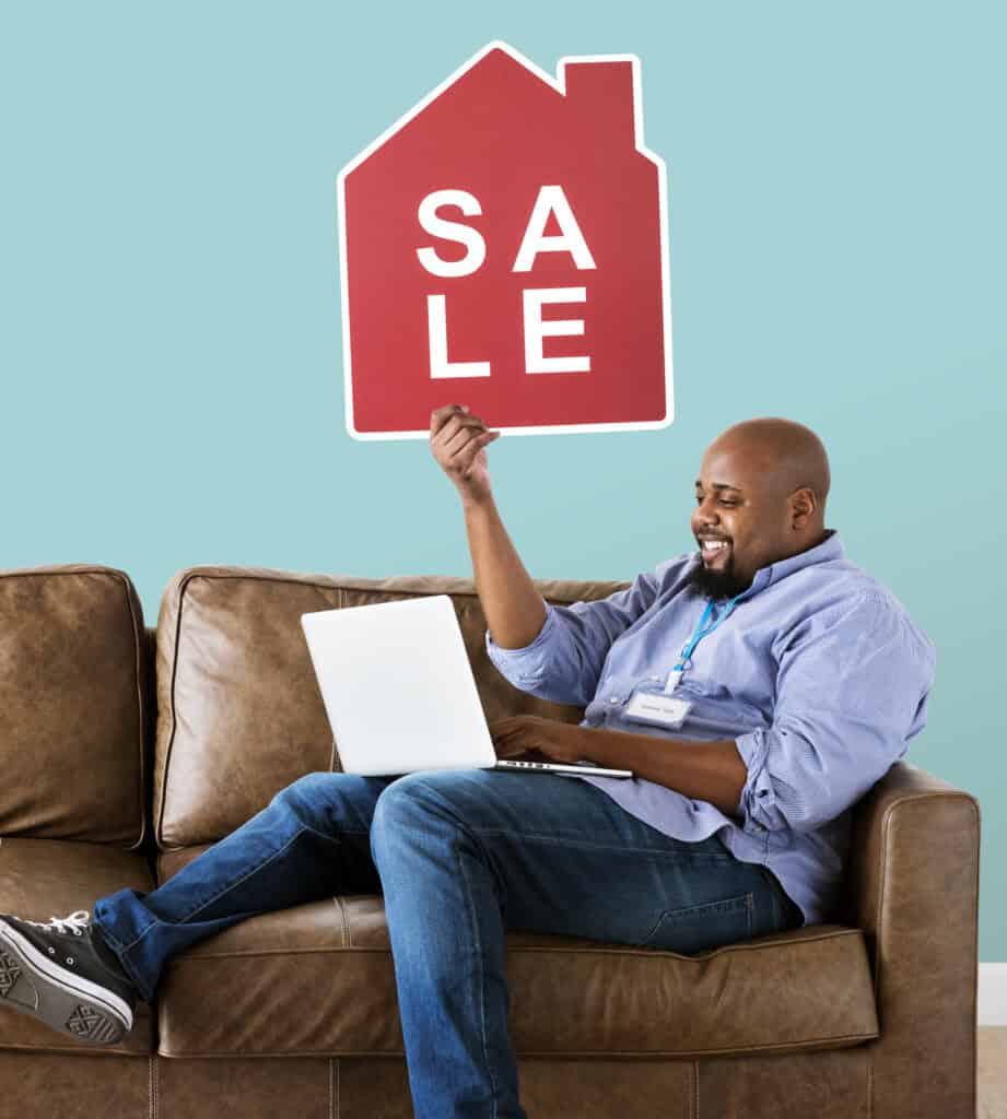 man holding house sale sign